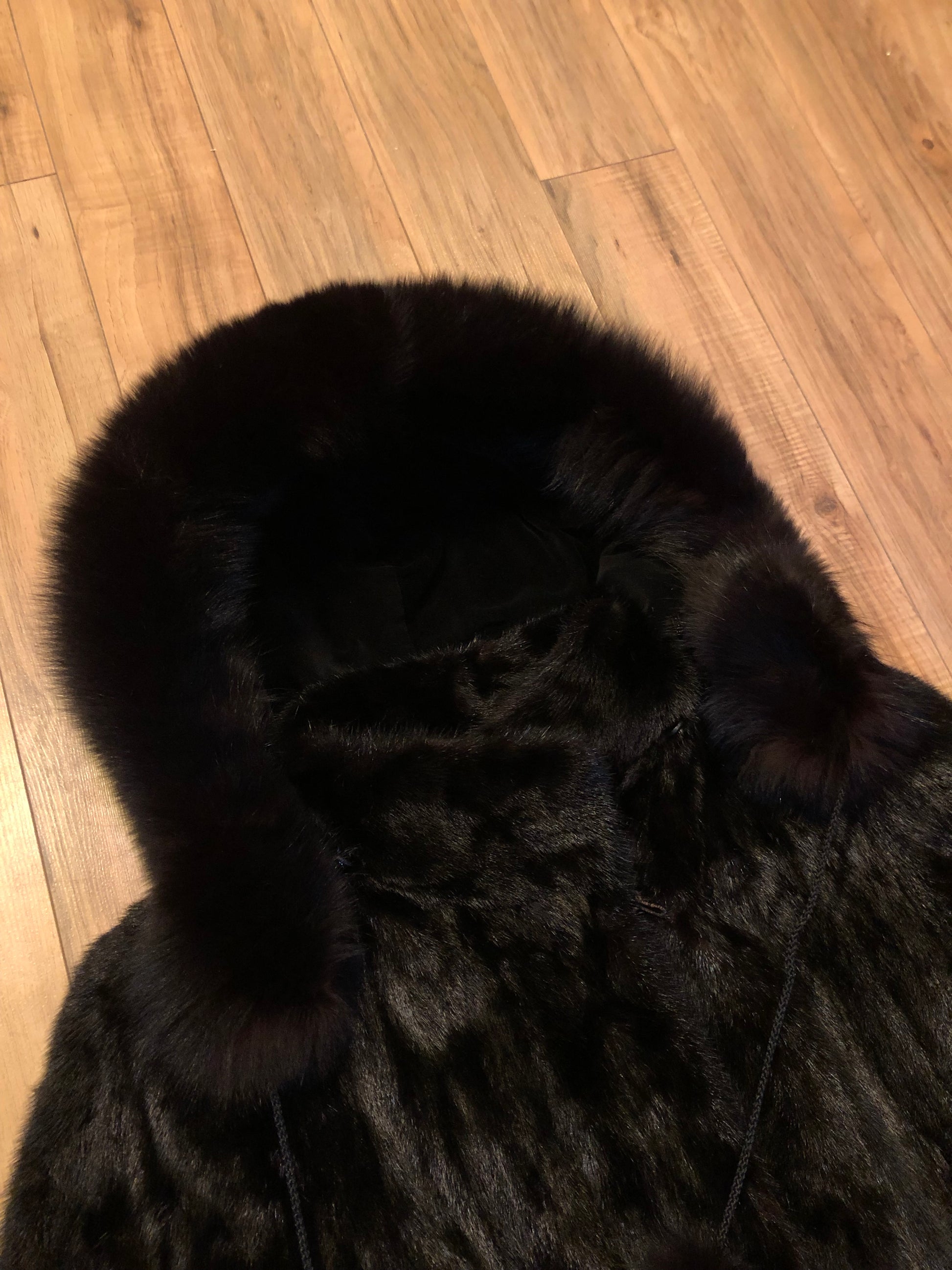 Kingspier Vintage - Vintage Furs by Offerman long fur coat with fur pom poms and a removable hood, hook and eye closures, pockets and an “M.R.M” monogram on the black satin lining.

Made in Nova Scotia, Canada.