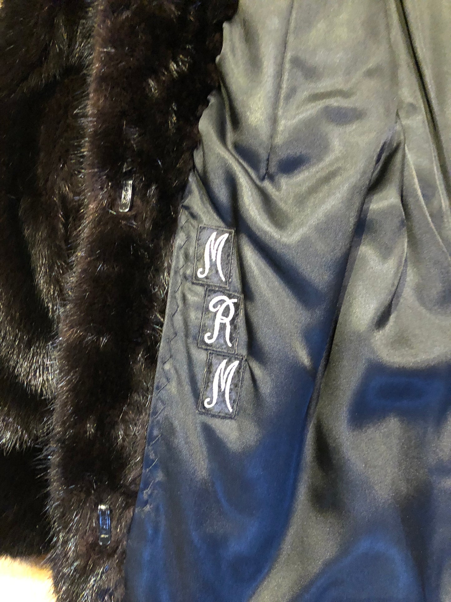 Kingspier Vintage - Vintage Furs by Offerman long fur coat with fur pom poms and a removable hood, hook and eye closures, pockets and an “M.R.M” monogram on the black satin lining.

Made in Nova Scotia, Canada.