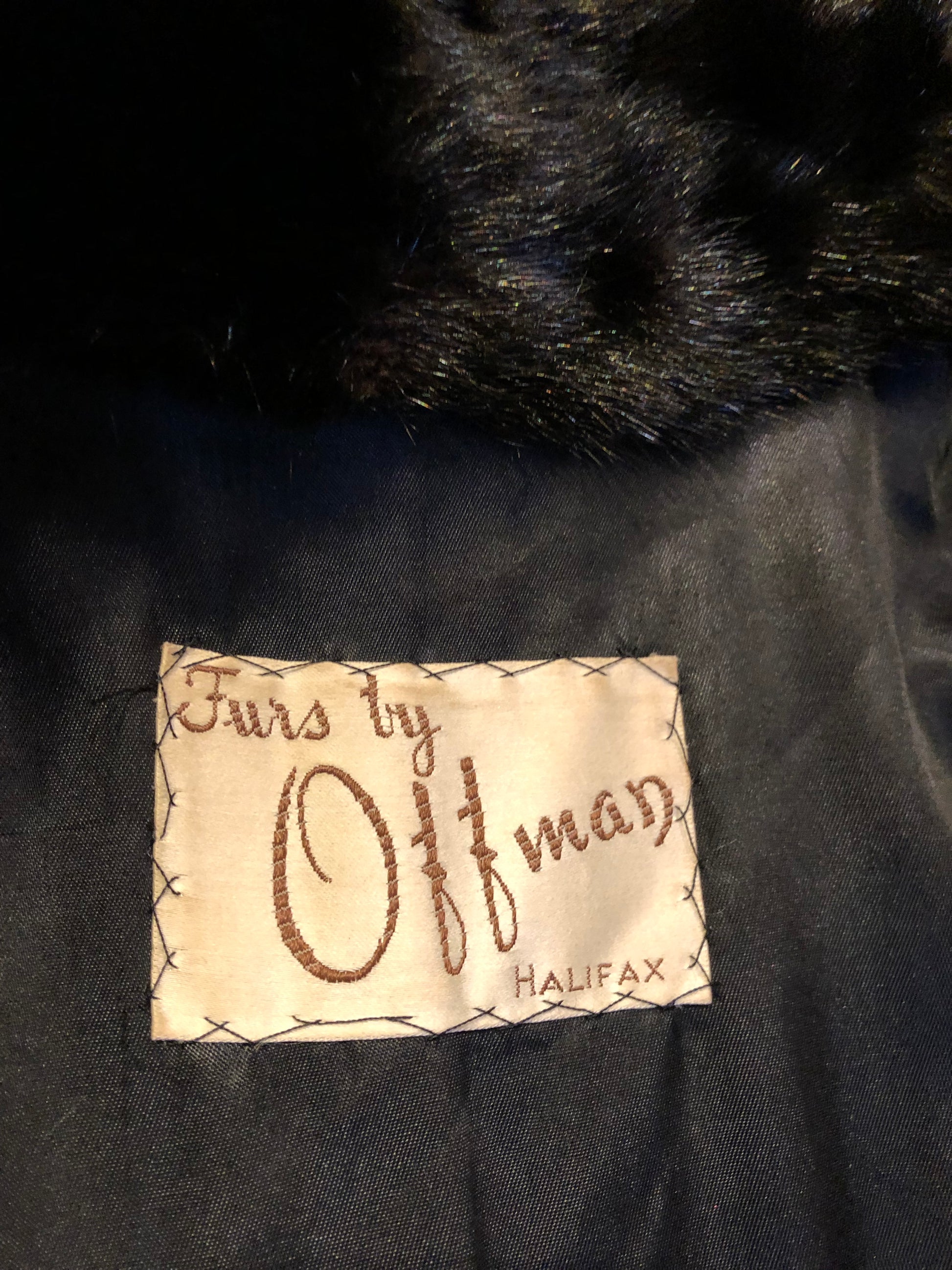 Kingspier Vintage - Vintage Furs by Offerman long fur coat with fur pom poms and a removable hood, hook and eye closures, pockets and an “M.R.M” monogram on the black satin lining.

Made in Nova Scotia, Canada.