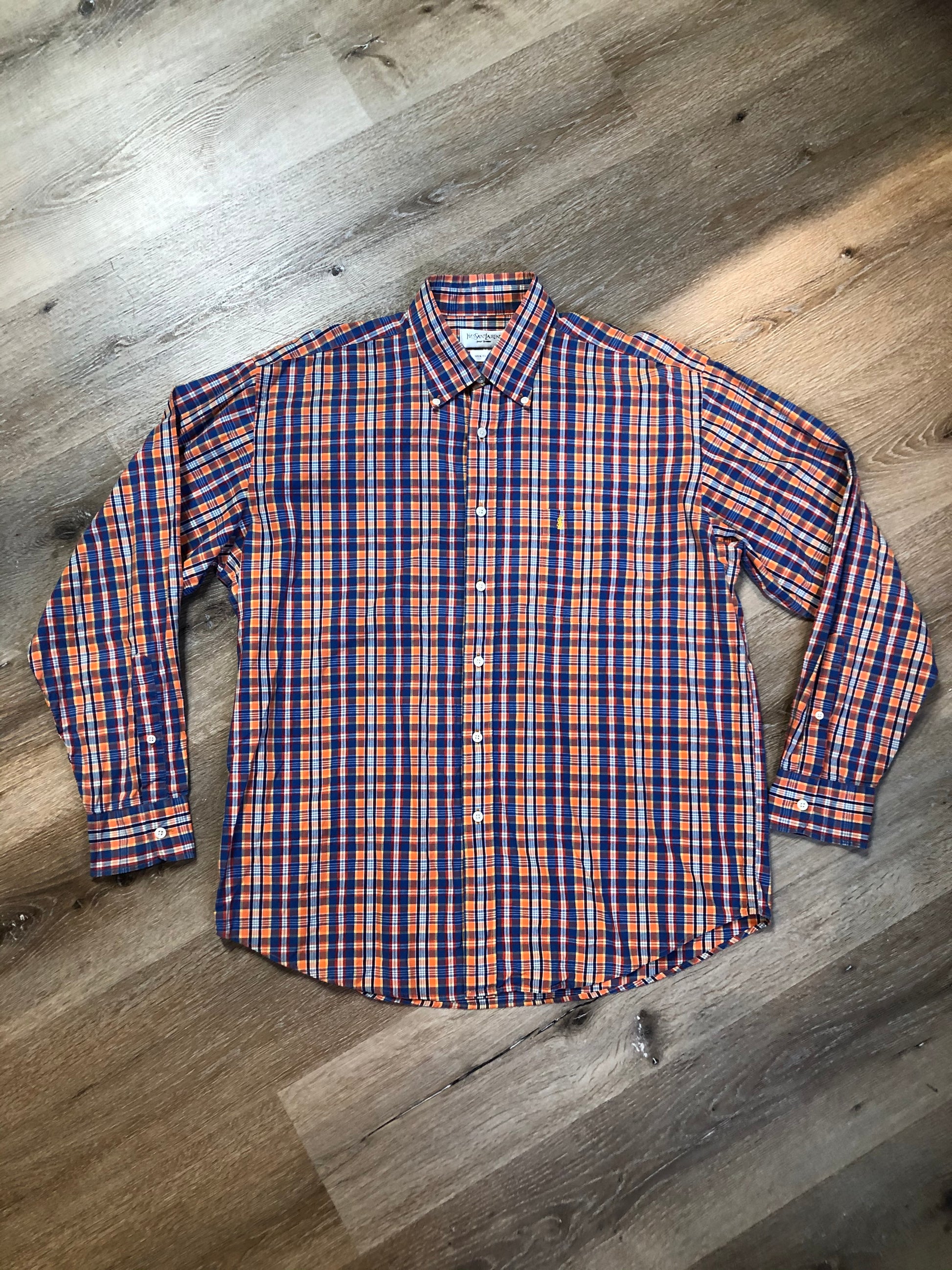 Kingspier Vintage - Yves St Laurent blue, orange yellow, green, white and red plaid button up shirt. 100% cotton with a small YSL logo on the chest. Size large mens.
