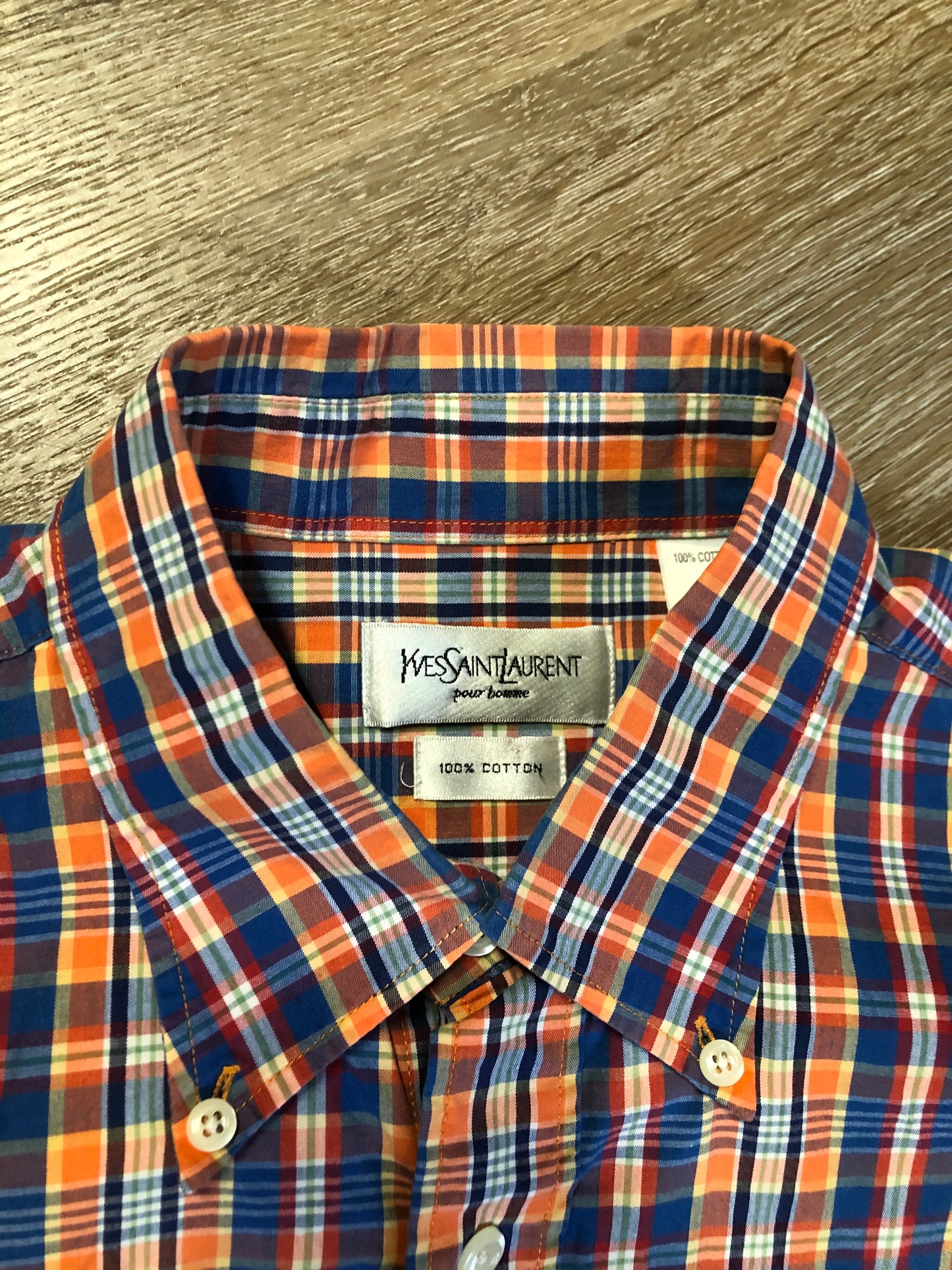 Kingspier Vintage - Yves St Laurent blue, orange yellow, green, white and red plaid button up shirt. 100% cotton with a small YSL logo on the chest. Size large mens.
