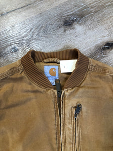 Kingspier Vintage - Carhartt tan bomber jacket with zipper closure, pockets, vertical zip pocket on chest, inside pocket and a lightweight lining. Women’s small.
