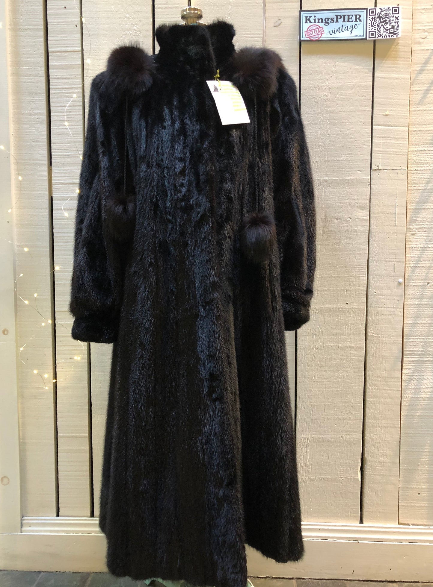 Kingspier Vintage - Vintage Furs by Offerman long fur coat with fur pom poms and a removable hood, hook and eye closures, pockets and an “M.R.M” monogram on the black satin lining.Made in Nova Scotia, Canada.