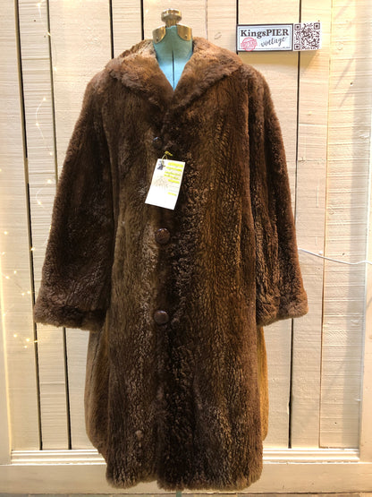 Kingspier Vintage - Vintage Vogue Furriers long fur coat circa 1970’s features leather button closures, two front pockets abd a brown satin lining.Made in Nova Scotia, Canada.Size Large.