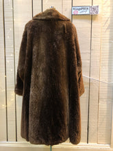 Load image into Gallery viewer, Kingspier Vintage - Vintage Vogue Furriers long fur coat circa 1970’s features leather button closures, two front pockets abd a brown satin lining.Made in Nova Scotia, Canada.Size Large.
