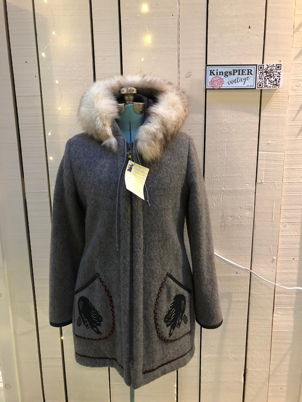 Kingspier Vintage - Vintage James Bay 100% virgin wool northern parka in grey. This parka features a fur trimmed hood, zipper closure, patch pockets, quilted lining, storm cuffs, leather trim, custom embroidery and a beaver design in felt applique. Made in Canada.Size small.