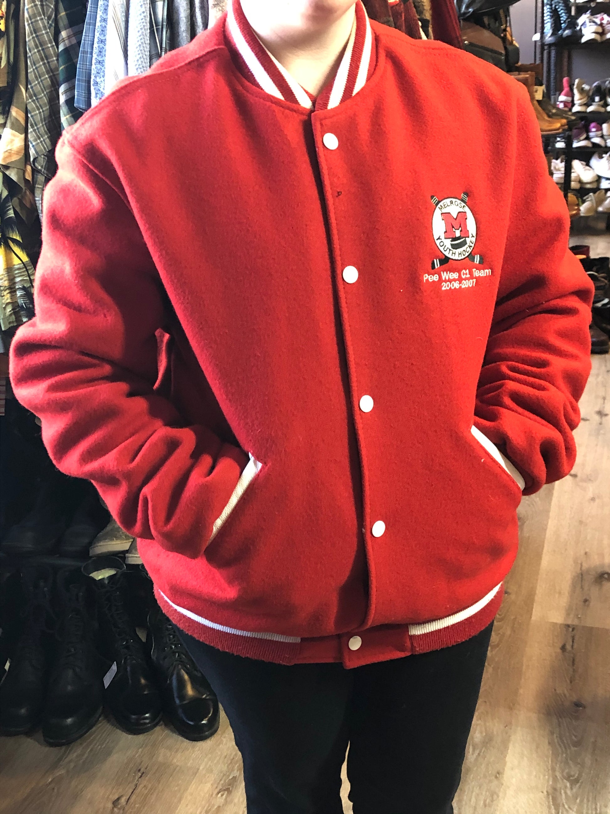 Kingspier Vintage - Melrose Youth Hockey letterman’s jacket in red with white accents, embroidered emblem on the front and lettering on the back with monogram on shoulder “Kevin”. Snap closures, slash pockets. Made in the USA. Size M.