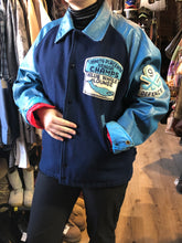 Load image into Gallery viewer, Trinity Placentia Senior Champs “Blue Whale Lounge “ blue varsity jacket with snap closures, slash pockets, embroidered emblem on chest and arm, “whalers” written across the back and a red lining. Size 44.
