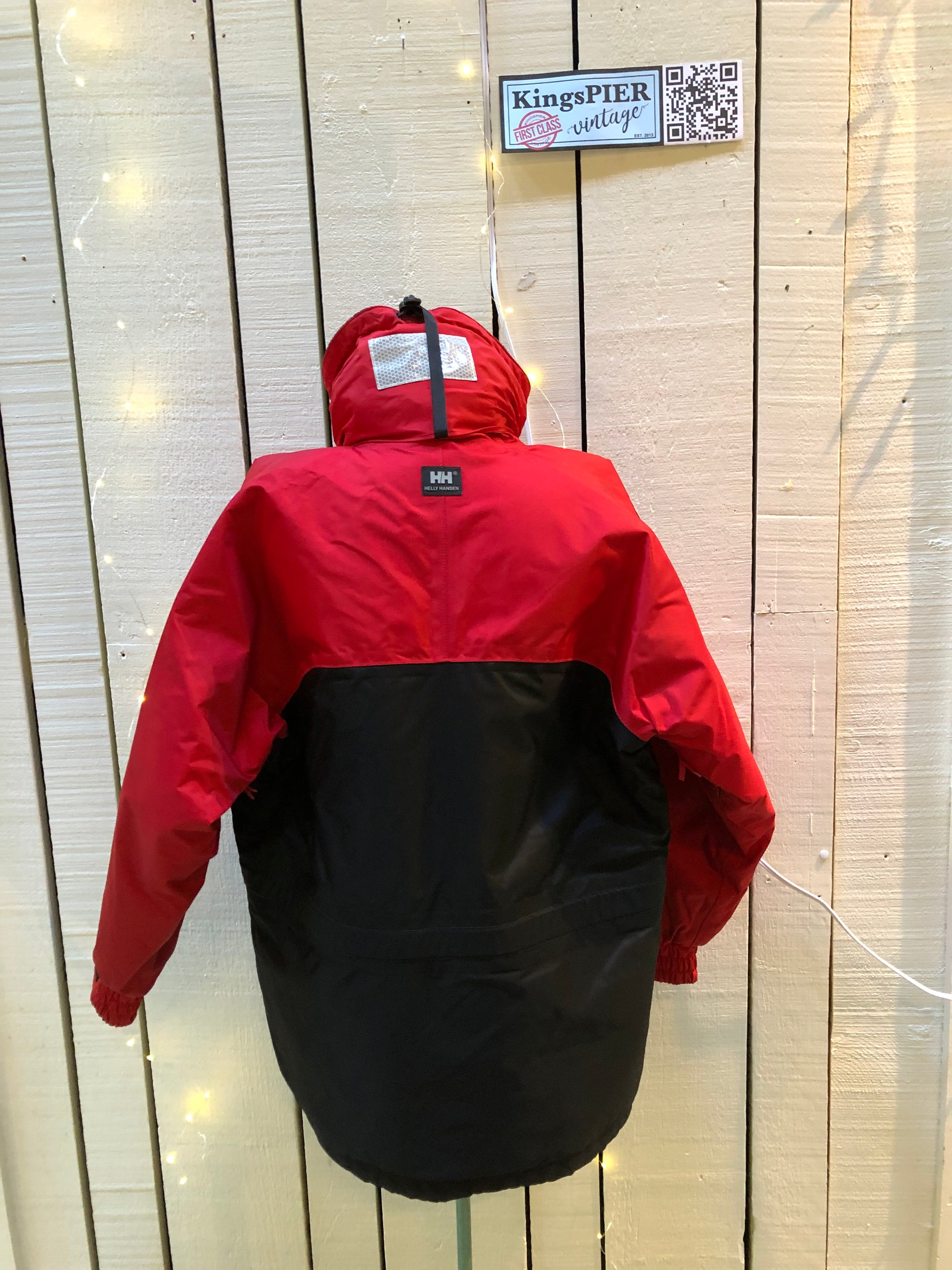 Kingspier Vintage - Helly Hansen red and black Soft Flex Echo Parka with Personal Flotation Device, Canadian Coast Guard approved.

Jacket features a packable hood, adjustable storm collar, zipper and snap closures, zip front pockets, waterproof shell, and PVC foam buoyant component.

Size Small.