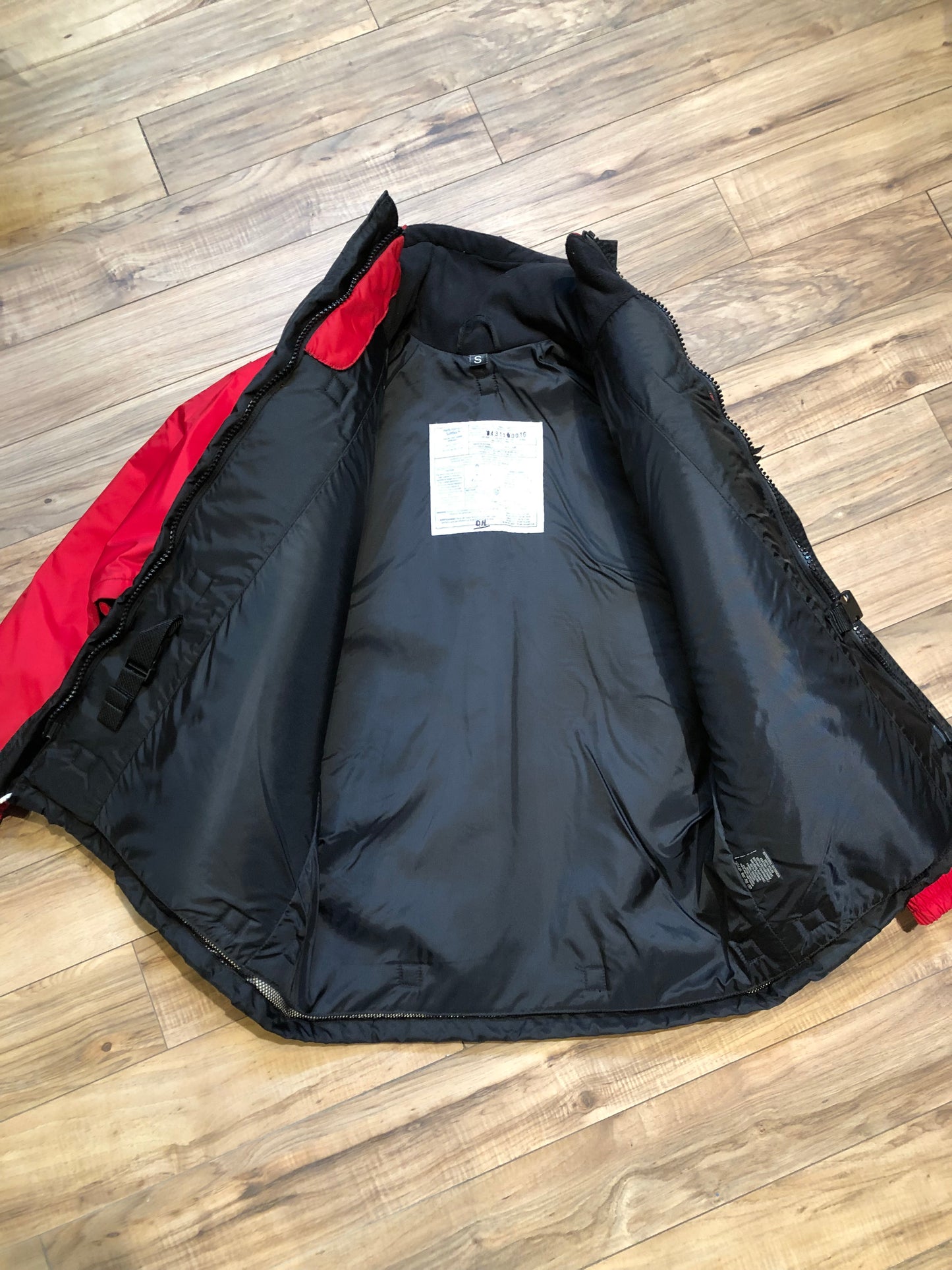 Kingspier Vintage - Helly Hansen red and black Soft Flex Echo Parka with Personal Flotation Device, Canadian Coast Guard approved.

Jacket features a packable hood, adjustable storm collar, zipper and snap closures, zip front pockets, waterproof shell, and PVC foam buoyant component.

Size Small.