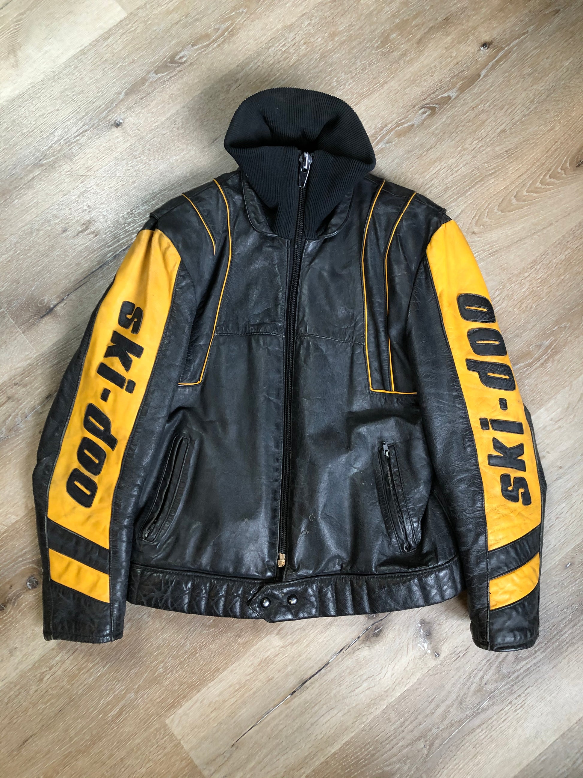 Kingspier Vintage - Bombardier Ski-Doo black and yellow leather jacket by Drospo with knit collar, zipper closure, zip pockets, quilted lining and one inside zip pocket. Made in Canada
