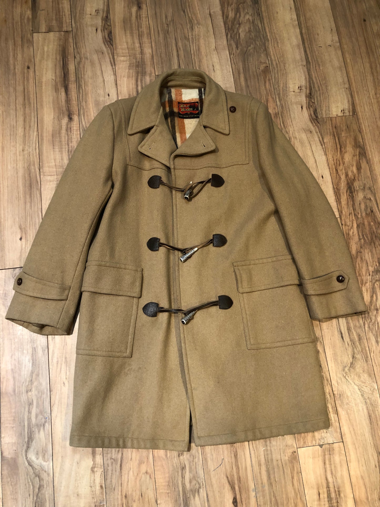 Kingspier Vintage - Wool blend coat (75% wool, 25% other) with fuzzy acetate lining, antler and leather toggle closures and front flap pockets.

Made in Canada.