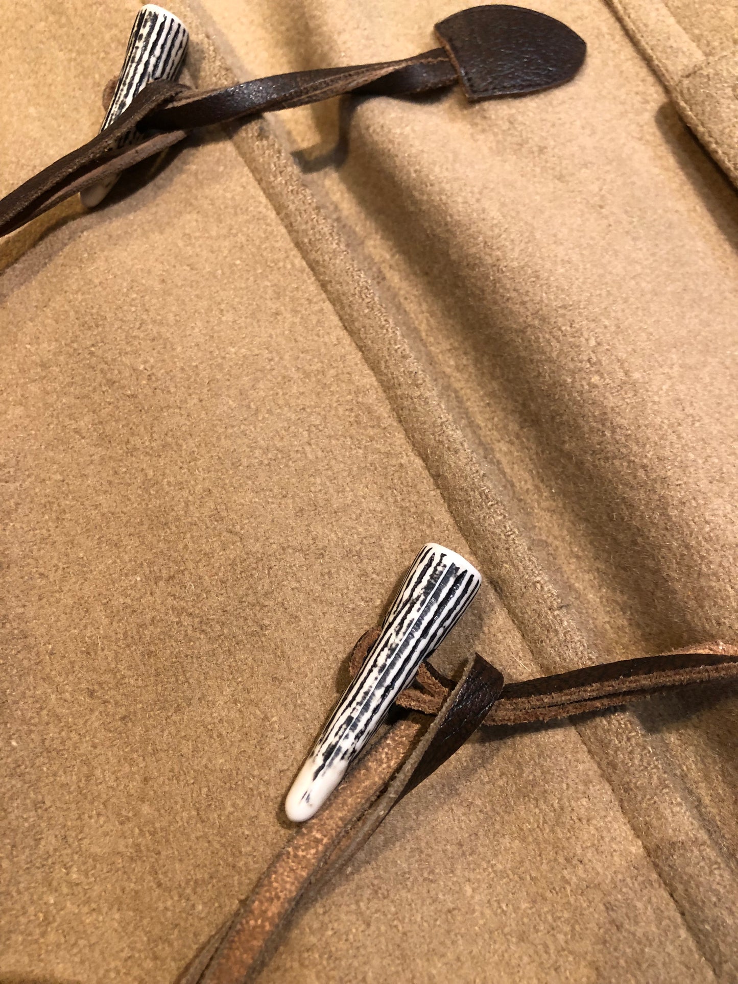 Kingspier Vintage - Wool blend coat (75% wool, 25% other) with fuzzy acetate lining, antler and leather toggle closures and front flap pockets.

Made in Canada.