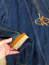 Load image into Gallery viewer, Kingspier Vintage - Vintage Knockout Jeans pullover denim jacket in a medium wash with quarter zip closure, embroidered logo on the front, knit cuffs, slash pockets, one patch pocket on the chest and a leather patch on the back. Size Xl. Made in USA

