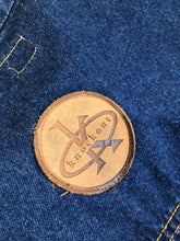 Load image into Gallery viewer, Kingspier Vintage - Vintage Knockout Jeans pullover denim jacket in a medium wash with quarter zip closure, embroidered logo on the front, knit cuffs, slash pockets, one patch pocket on the chest and a leather patch on the back. Size Xl. Made in USA

