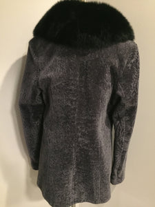 Kingspier Vintage - <p>This unusual mottled grey shearling 3/4 jacket is velvetty and supple. <br> The finish is silky and soft and the satin lining is a dramatic print of stylized wild animal hide designs.<br> The rich black long haired shawl collar lends a sophisticated compliment to the subtle grey palette of the jacket and the fine leather detail trims.</p>
<p>This piece is in gorgeous as new condition.</p>
