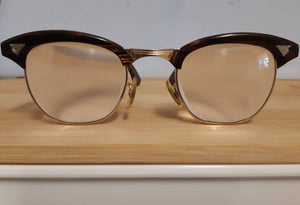 Extremely rare vintage redwood & gold American Optical Sirmont combination eyeglasses made famous by Malcolm X, SOLD
