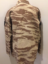 Load image into Gallery viewer, Kingspier Vintage - This desert camouflage light military jacket is in great condition. Made of cotton with 4 large cargo pockets, velcro rank patches, and &quot;Houston&quot; embroidered name patch. Size L.
